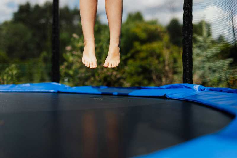 feet jumping on a trampoline